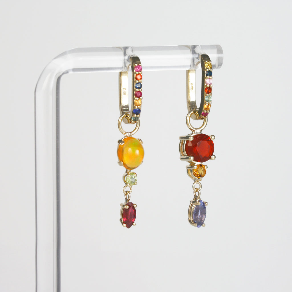 Each hoop is adorned with a unique arrangement of multicolor sapphires in vivid hues, which have been carefully handpicked to create mesmerizing combinations. 