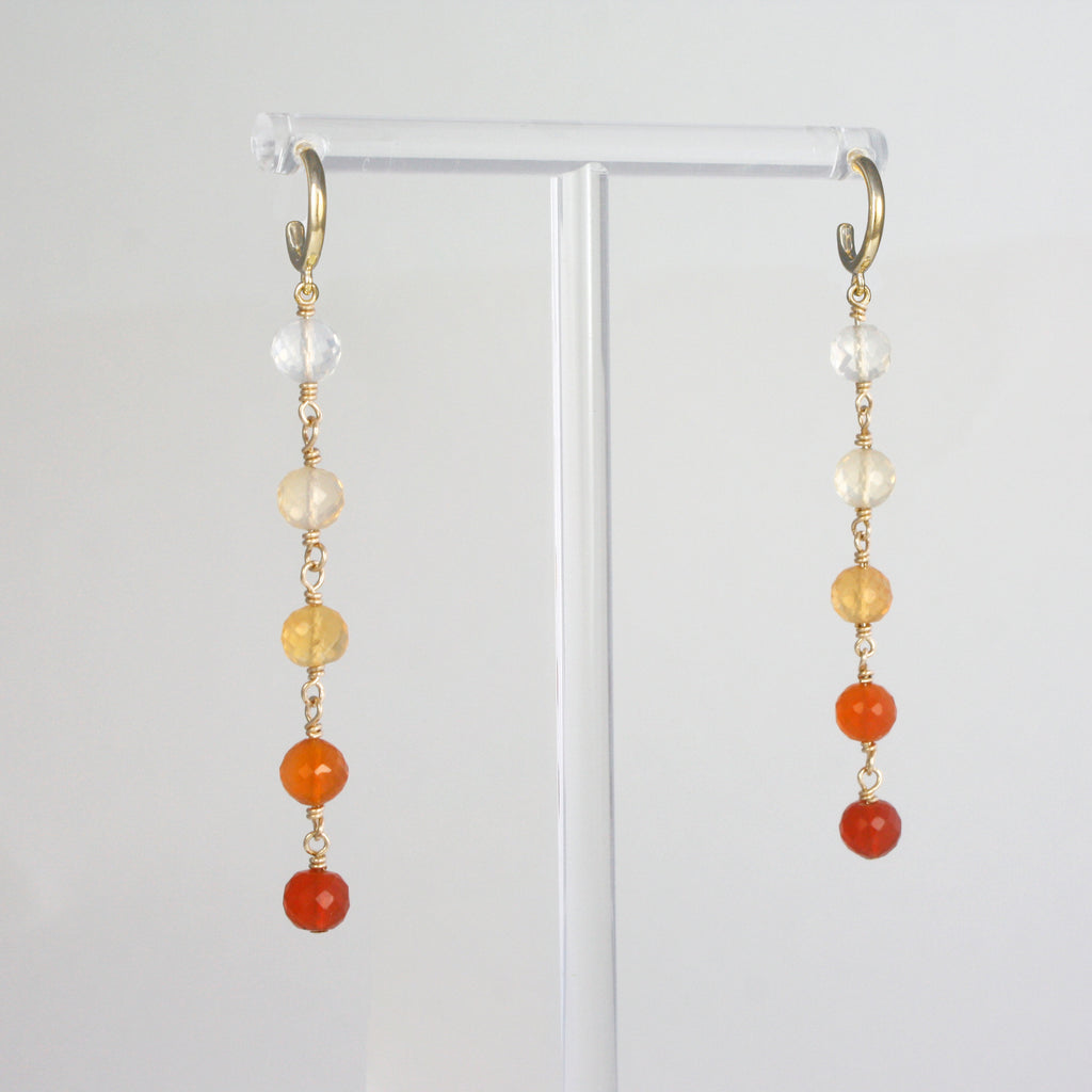 This unique pair of earrings highlights the exquisite range of fire opal tonalities. From an intense orange-red to transparent, all beautiful colors set up in a vivid gradient.