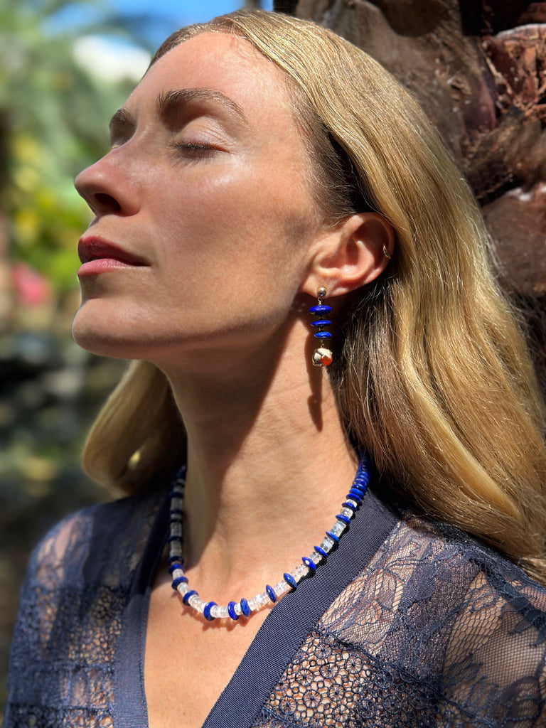 Deep blue lapis lazuli with hints of pyrite pairs with raw orange Mexican boulder opal for a bold contrast. Set in gold, the mix of smooth facets, earthy texture and vibrant color makes this pair truly stand out.&nbsp;