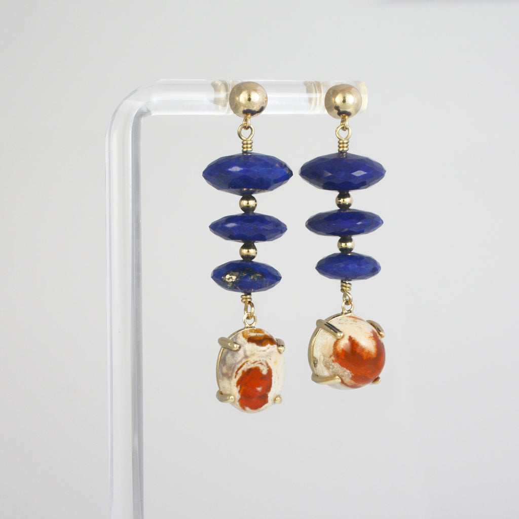 Deep blue lapis lazuli with hints of pyrite pairs with raw orange Mexican boulder opal for a bold contrast. Set in gold, the mix of smooth facets, earthy texture and vibrant color makes this pair truly stand out.&nbsp;