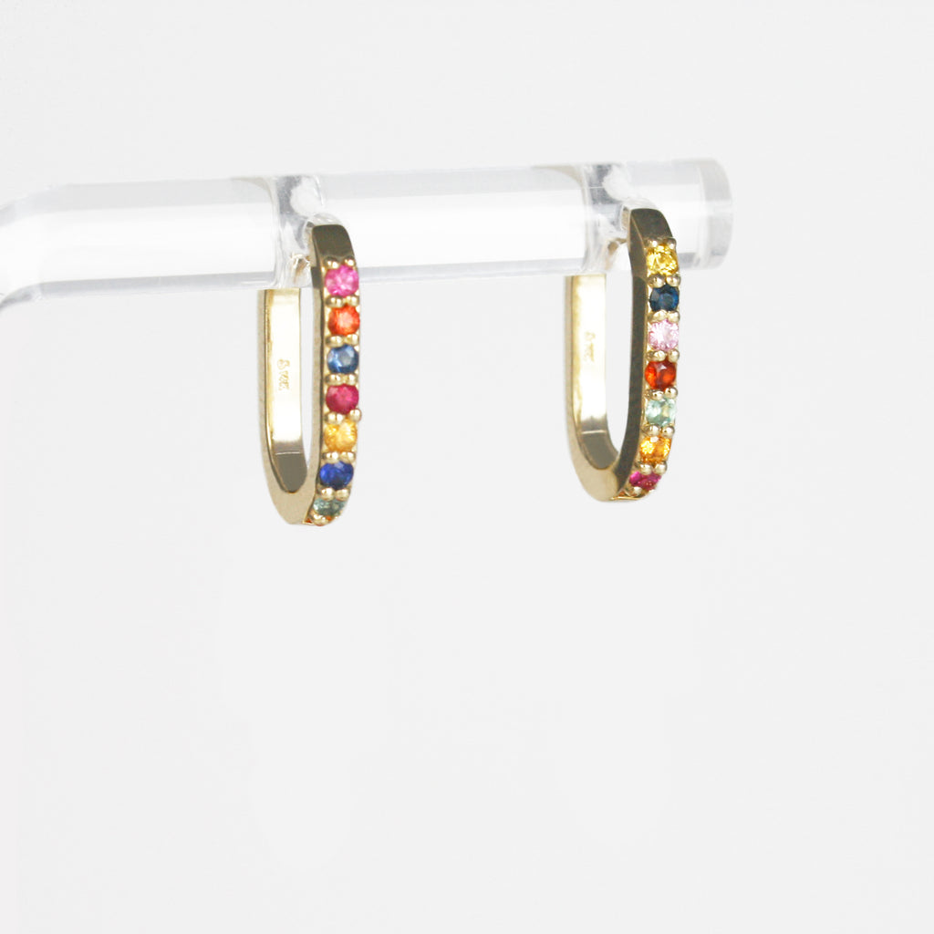 Each hoop is adorned with a unique arrangement of multicolor sapphires in vivid hues, which have been carefully handpicked to create mesmerizing combinations. 