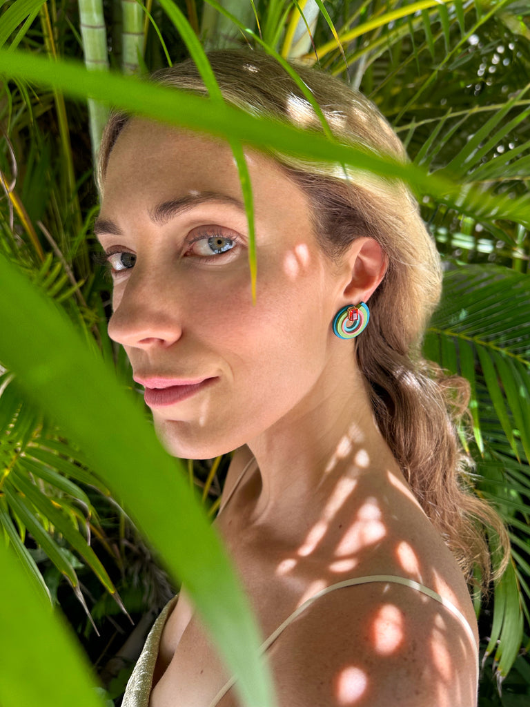 Inspired by the Universe and its infinite mysteries, these exquisite one-of-a-kind earrings are carefully made by hand, with attention to every step of the process. They consist of black walnut, which is treated to make it stronger and more resistant, and delicately hand-painted with top-quality acrylic paint. Mexican orange crystal opals are set in 14k yellow gold, making them eye-catching and unique.