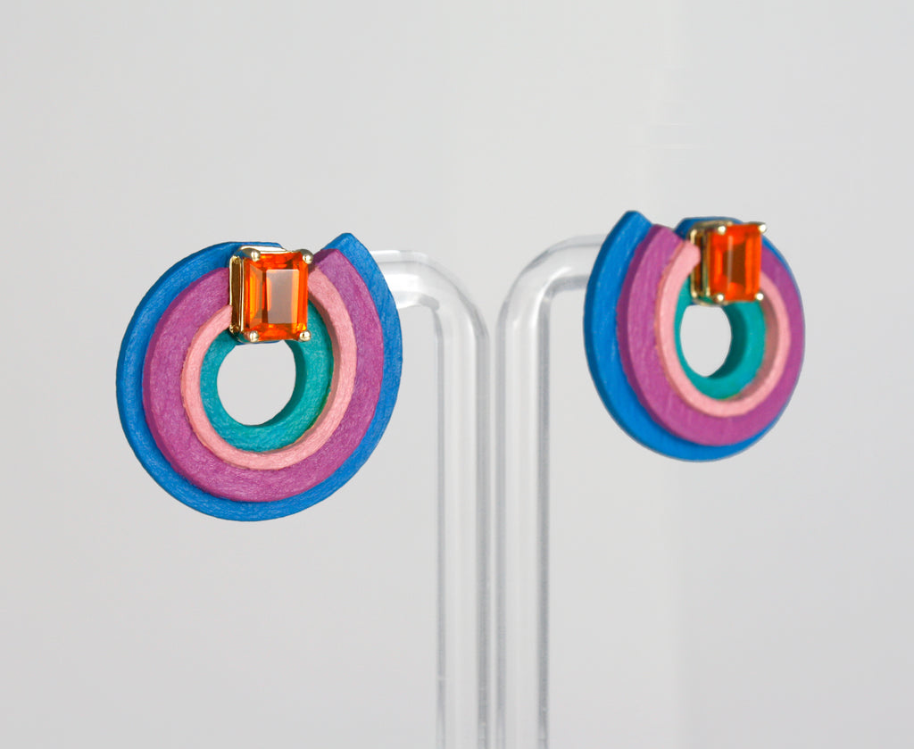 Inspired by the Universe and its infinite mysteries, these exquisite one-of-a-kind earrings are carefully made by hand, with attention to every step of the process. They consist of black walnut, which is treated to make it stronger and more resistant, and delicately hand-painted with top-quality acrylic paint. Mexican orange crystal opals are set in 14k yellow gold, making them eye-catching and unique.