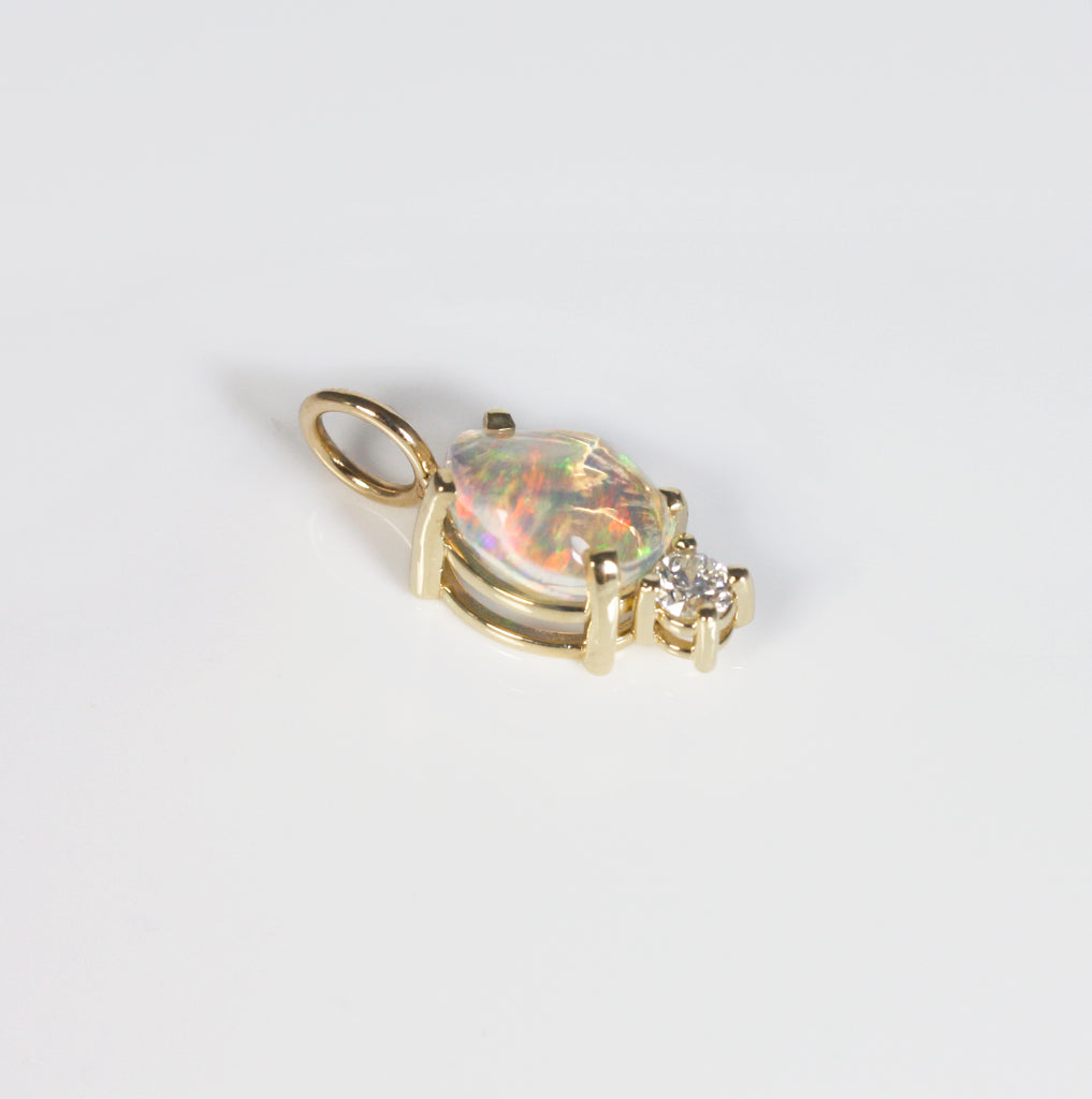 Enchanting raw Mexican crystal opal with rainbow fire, set alongside a sparkly diamond. 