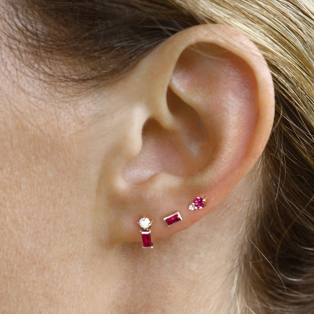 This dainty stud consists of a vivid dark pink ruby set alongside a Mexican white opal. 
