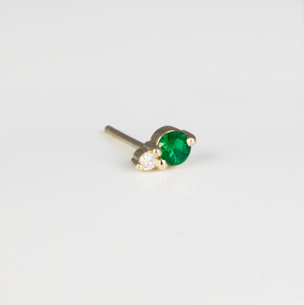 This dainty stud consists of a vivid emerald set alongside a sparkly diamond. 
