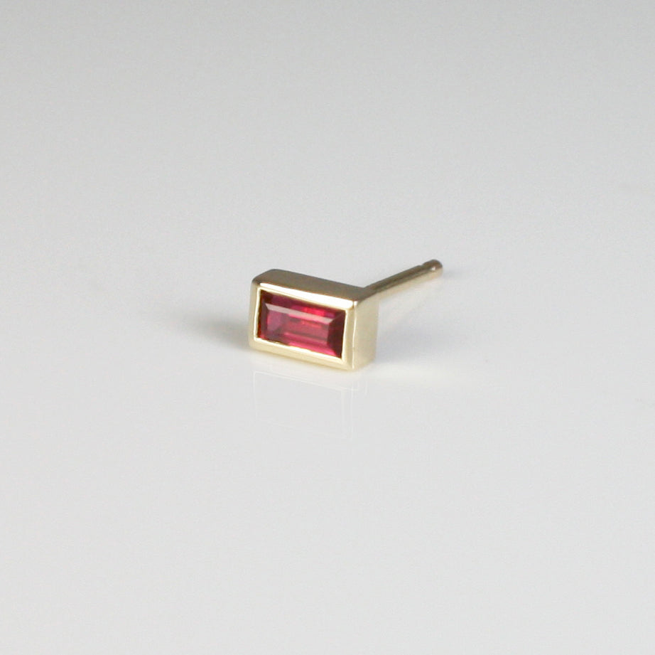 This dainty ruby baguette stud is perfect for your ear stack, as well as for an understated everyday look.