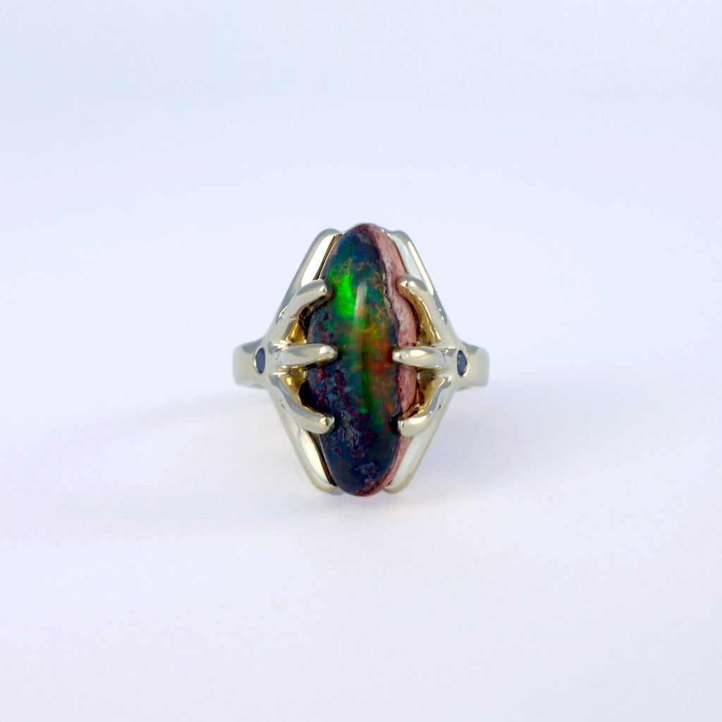 Mexican boulder crystal opal and black diamond ring set in 14k yellow gold.