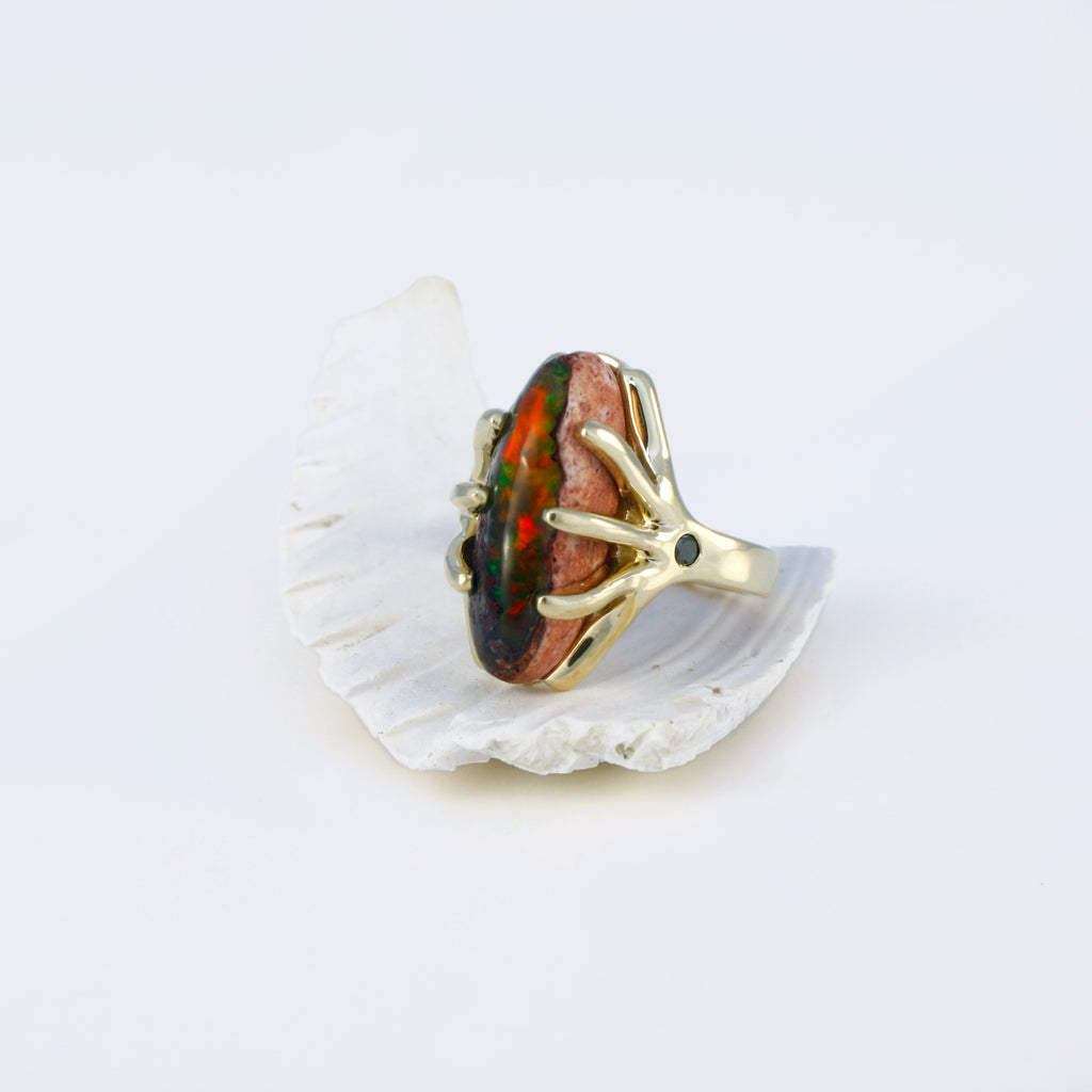 Mexican boulder crystal opal and black diamond ring set in 14k yellow gold.