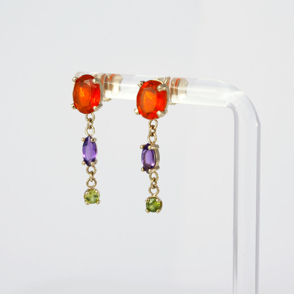 These stunning chain earrings are full of movement and lively colors. They feature vibrant Mexican fire opals, amethysts and peridots set in 14k gold. 