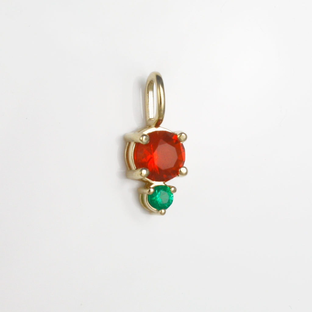 Vibrant red-orange Mexican fire opal alongside a lively emerald.
