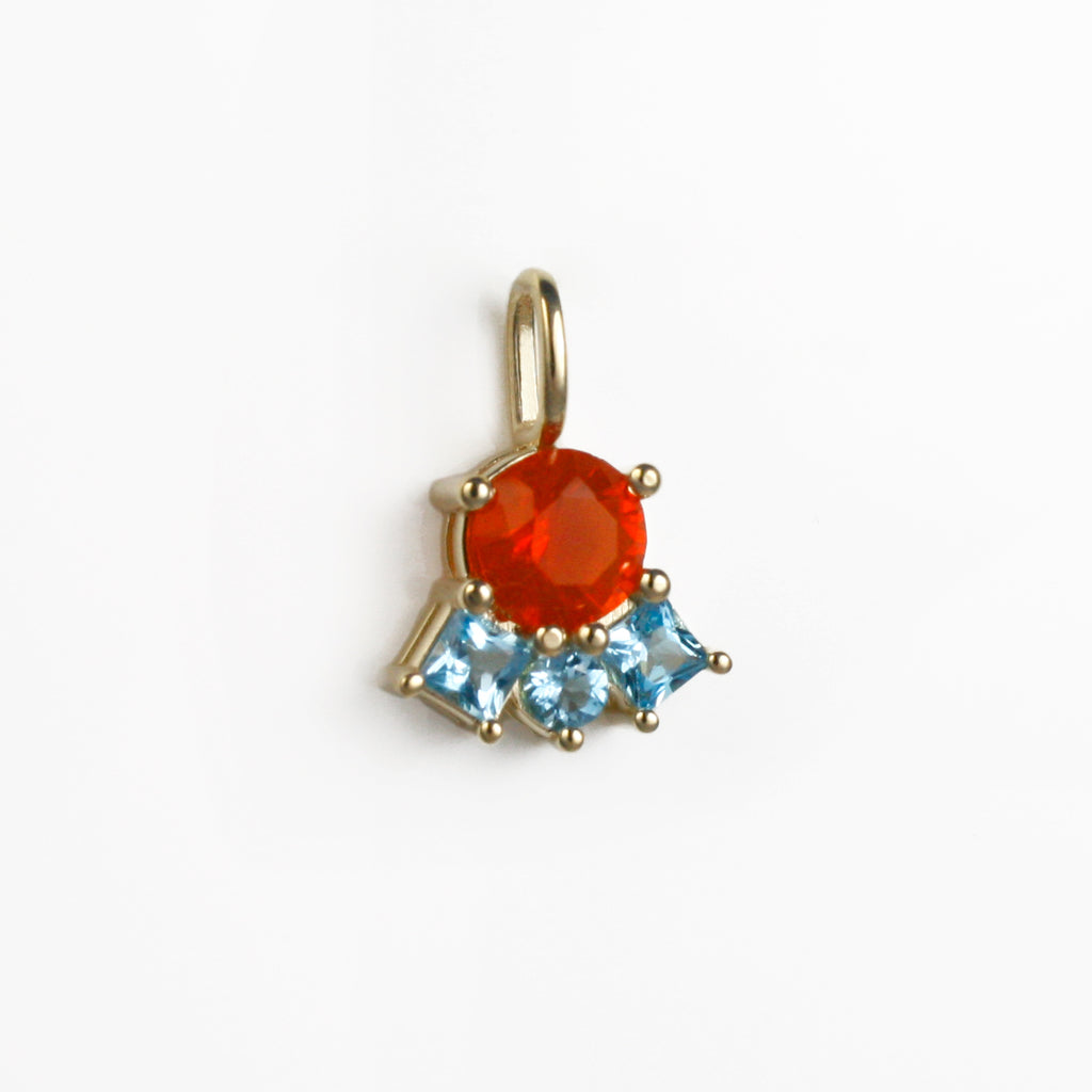 Vibrant Mexican fire opal contrasted by three lively blue topaz.