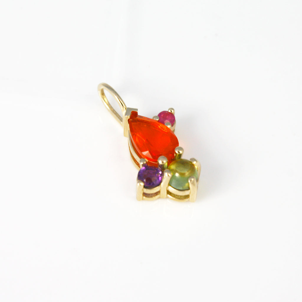 This lively 14k gold charm features a Mexican fire opal contrasted by a tourmaline, an amethyst and a ruby. 
