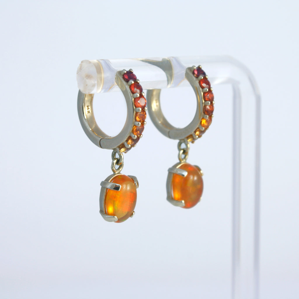 Vibrant Mexican orange crystal opals suspended from 14k gold hoops sprinkled with colored sapphires in a gradient tone.