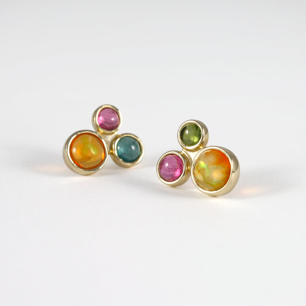 A classic triad featuring Mexican orange crystal opal and colorful contrasting tourmalines mounted in 14k gold.