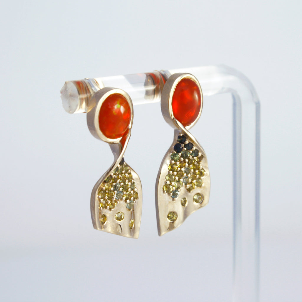 Vibrant Mexican orange crystal opal and a sprinkle of tourmalines set in a pair of 14k gold earrings that twist and turn in a unique way. 