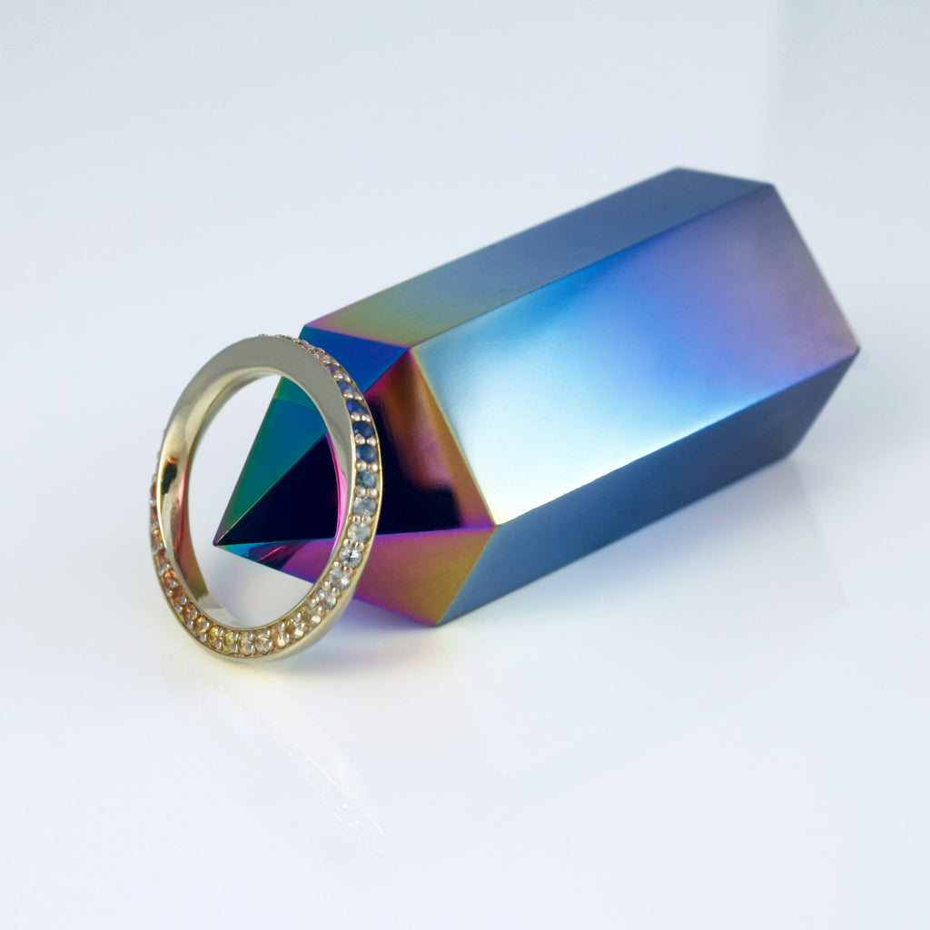 Twisted 14k gold ring sprinkled with multicolored sapphires creating the perfect rainbow gradient. A delicate and mystical piece inspired by the visible spectrum. 