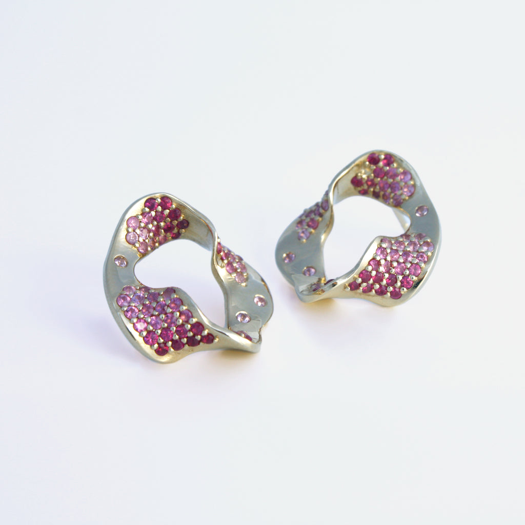 These sophisticated and eye-catching earrings twist and turn making us move through the different perspectives and dimensions present in this stunning pair.
