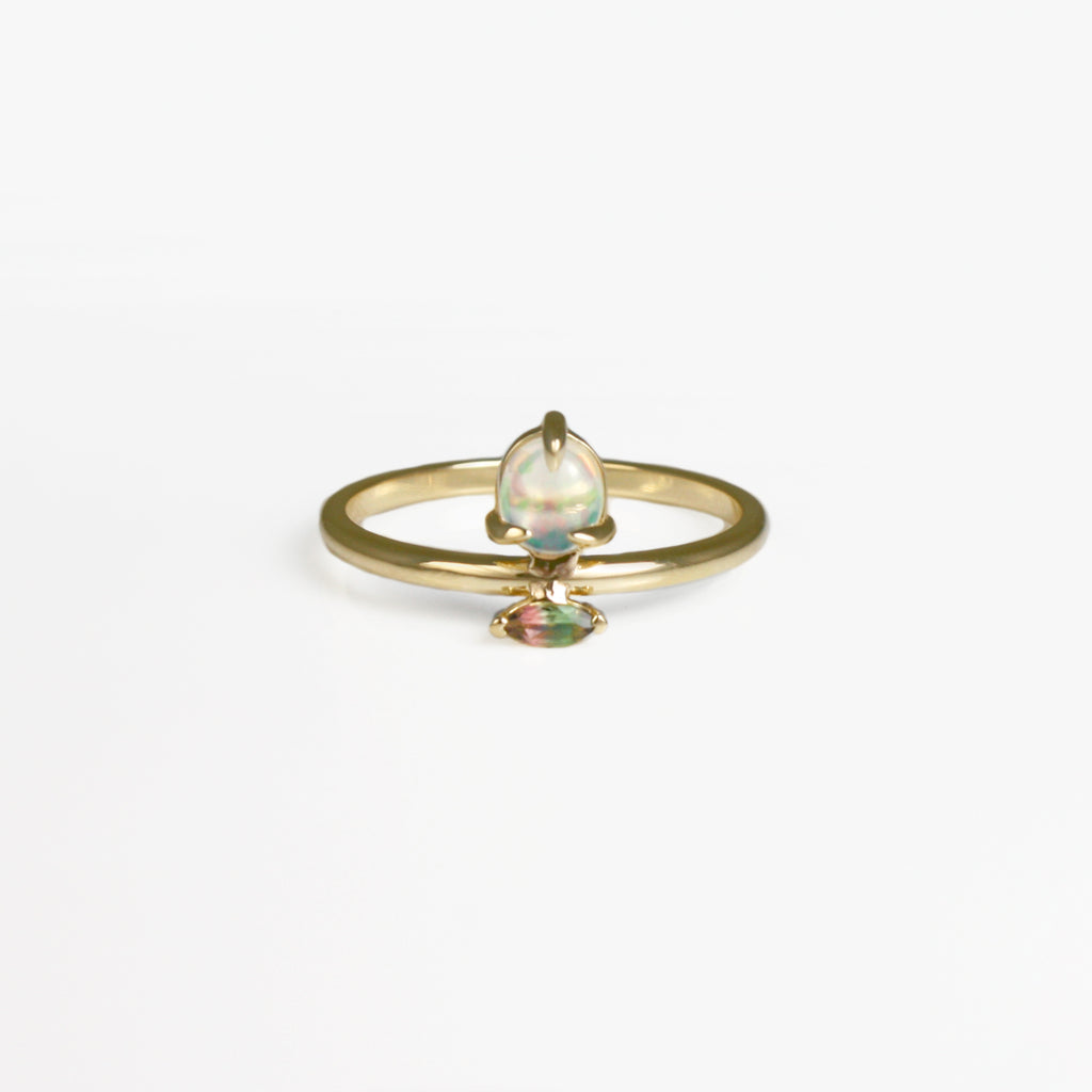 Delicate and femme, this exquisite ring features a Mexican crystal opal with green-red fire that perfectly matches the watermelon tourmaline set next to it.