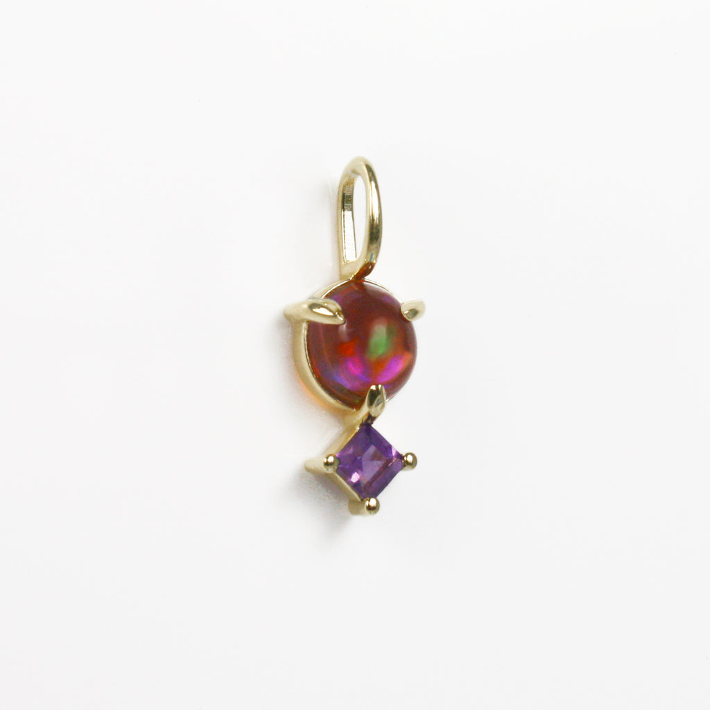 Mexican orange crystal opal with purple, blue, green and red fire alongside a vibrant amethyst.